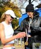 howard hands beth her marathon medal